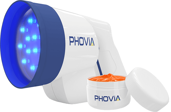 A handheld Phovia device with blue LED lights next to an open container of orange gel labeled "Phovia.
